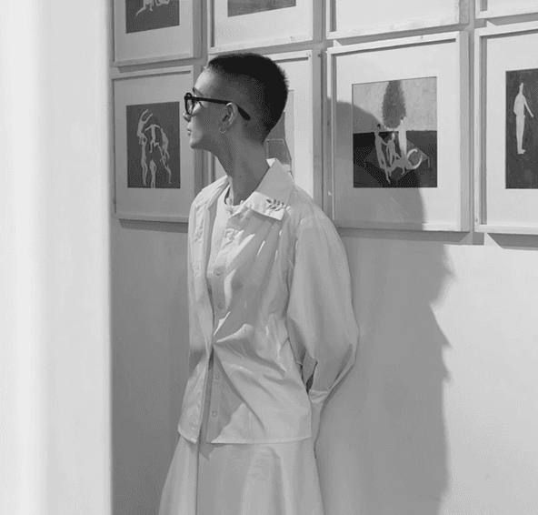 Marjan Tabrizi standing beside framed artworks